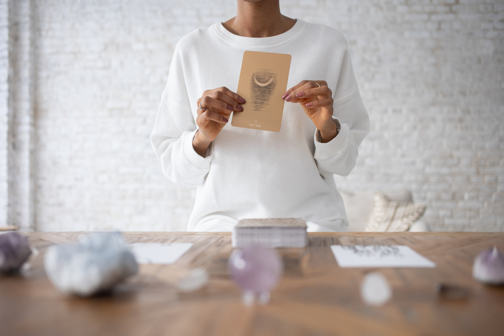 A Person in White Long Sleeves Holding a Card 